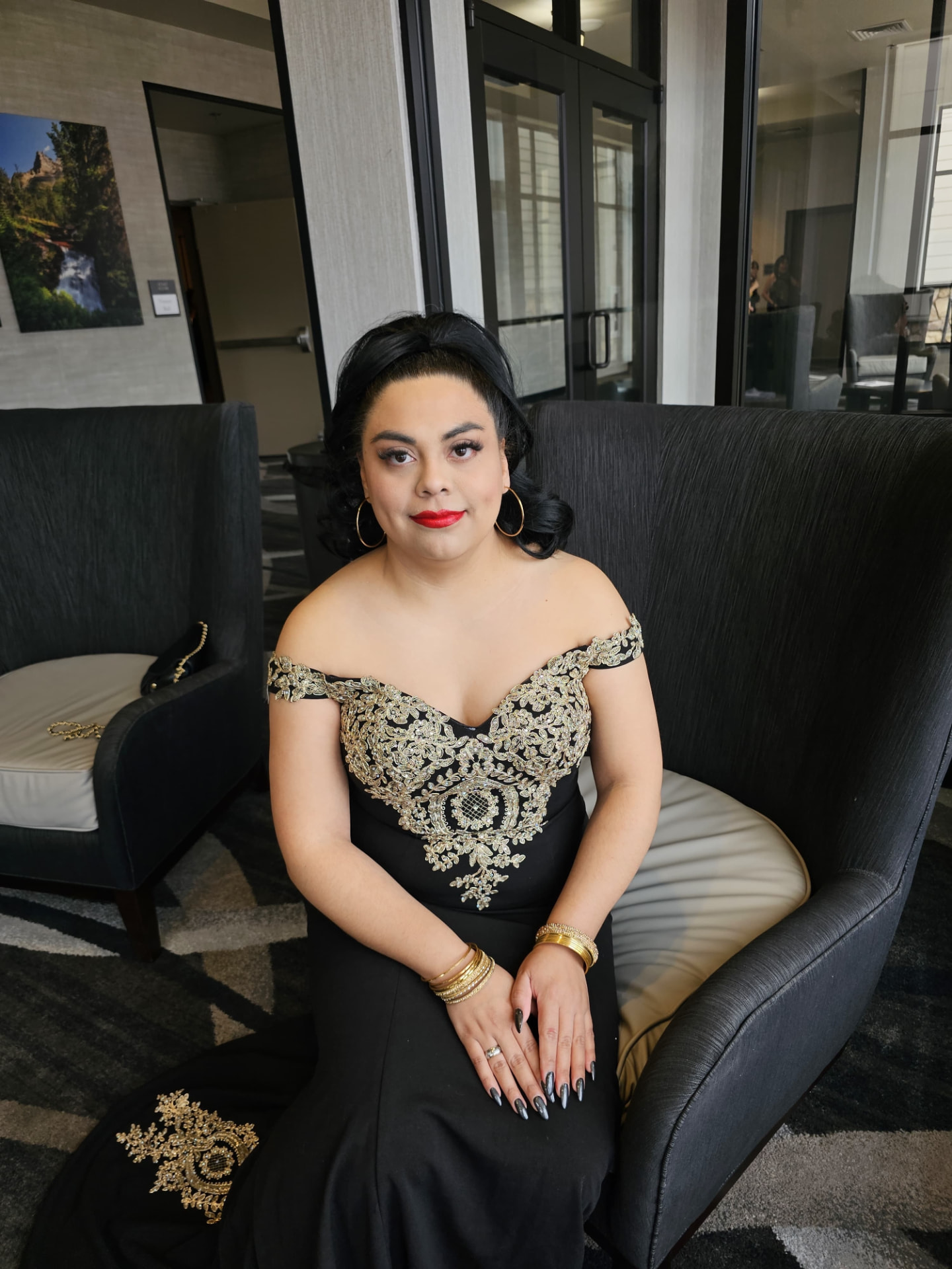 Susana Zempoalteca in a black and gold gala gown